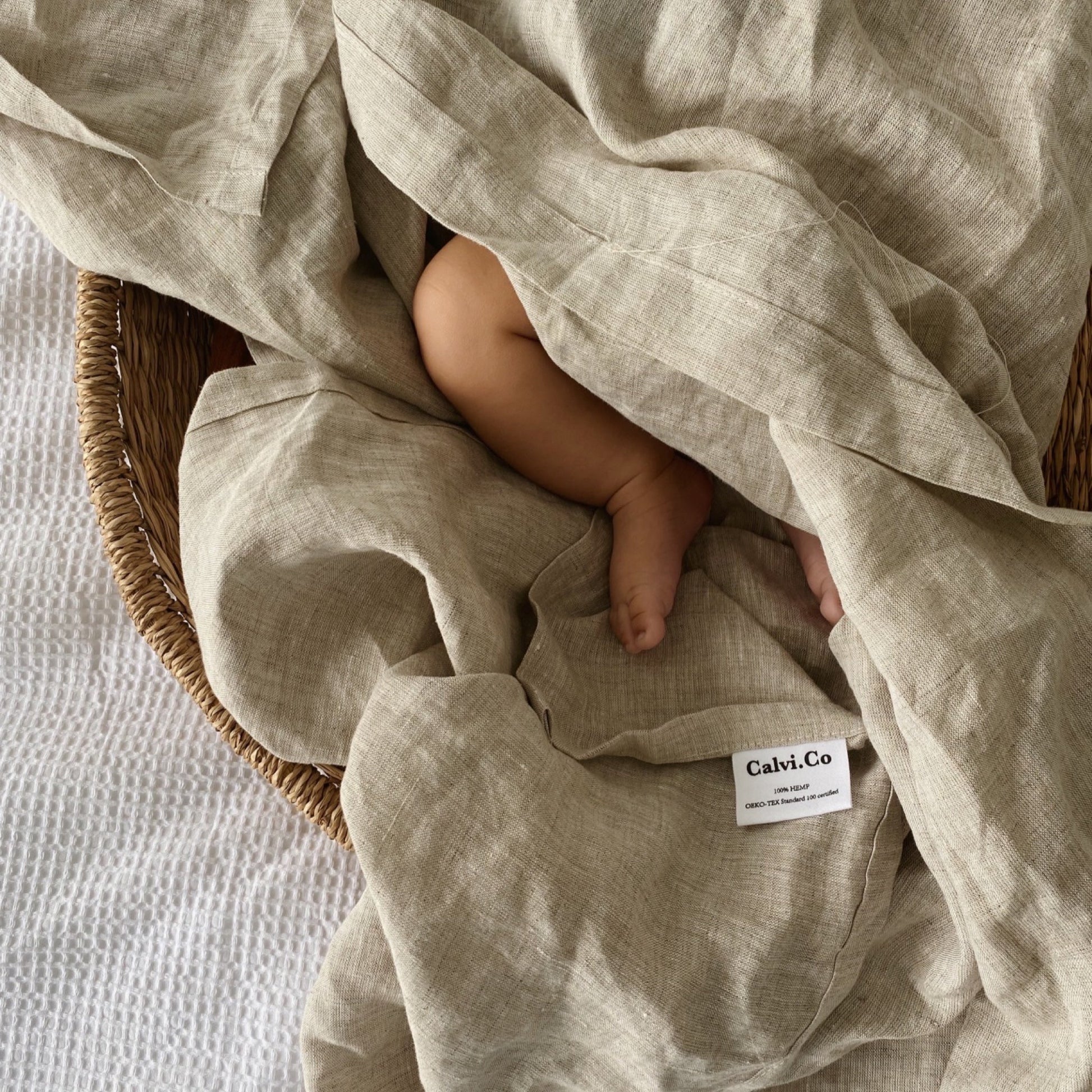 cute baby feet in natural pure hemp swaddle